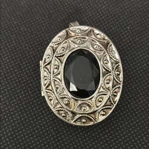 Avon empty solid perfume compact. Oval shape, filigree cover. Pin or pendant.